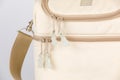 Closeup studio shot of cream and beige color multifunction multipurpose utility compartments zipper newborn baby toddler mommy bag