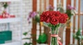 Closeup studio shot fresh red and pink petal roses bunch bouquet in glass vase placed on workshop table with other colorful Royalty Free Stock Photo