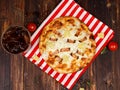 Closeup studio shot hot oven baked tasty delicious Italian homemade ham pineapple traditional Hawaiian bread crust round pizza Royalty Free Stock Photo