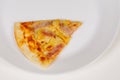 Closeup studio shot of one piece of tasty delicious Italian homemade mozzarella cheesy ham and pineapple original Hawaiian pizza