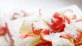 Closeup studio shot of Red paper wrapped present gift boxes with gold ribbon bowtie covered by white snow placed on wood table Royalty Free Stock Photo