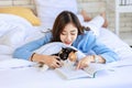 Closeup studio shot of tricolor cute little fat short hair purebred kitten pussycat companion laying down resting relaxing on bed Royalty Free Stock Photo