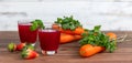 Closeup studio shot two glasses of freshly blended squeezed decorated with strawberry and carrot healthy diet vegan drink fresh