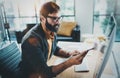 Closeup of stylish bearded designer working at sunny loft studio.Man using contemporary desktop computer.Horizontal Royalty Free Stock Photo