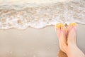 Closeup of  with stylish flip flops on sand near sea, space for text. Beach accessories Royalty Free Stock Photo