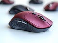 Closeup of a stylish, red gaming mouse with textured surface. Multiple blurred mice in the background create a sense of depth and