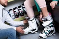 Closeup of ski boots on female legs during fitting in shop of sports equipment Royalty Free Stock Photo