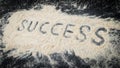 Closeup of success text written on white sand Royalty Free Stock Photo