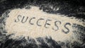 Closeup of success word written on white sand Royalty Free Stock Photo