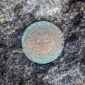 Closeup of summit geological survey marker on the op of Mount Marcy, Adirondacks Upstate New York