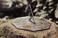 Closeup of a sunlit sundial set in a stone blurred background Royalty Free Stock Photo