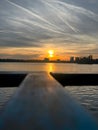 Closeup of sunset reflecting on lake with selective focus on background Royalty Free Stock Photo