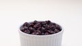 Closeup Superfood Heap Of Dried Cranberries In White Bowl On Beige Background. Selective