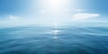 Closeup surface of calm ocean blue sea water with sunshine and clouds behind. Abstract Background Texture. Royalty Free Stock Photo