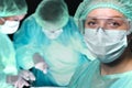 Closeup of surgeons performing operation. Focus on female doctor. Medicine, surgery and emergency help concepts Royalty Free Stock Photo