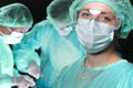 Closeup of surgeons performing operation. Focus on female doctor. Medicine, surgery and emergency help concepts Royalty Free Stock Photo