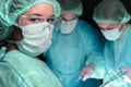 Closeup of surgeons performing operation. Focus on female nurse. Medicine, surgery and emergency help concepts Royalty Free Stock Photo