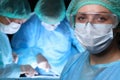 Closeup of surgeons performing operation. Focus on female nurse. Medicine, surgery and emergency help concepts Royalty Free Stock Photo