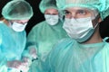 Closeup of surgeons performing operation. Focus on male doctor. Medicine, surgery and emergency help concepts Royalty Free Stock Photo