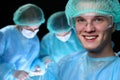 Closeup of surgeons performing operation. Focus on male doctor. Medicine, surgery and emergency help concepts Royalty Free Stock Photo