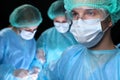 Closeup of surgeons performing operation. Focus on male doctor. Medicine, surgery and emergency help concepts Royalty Free Stock Photo