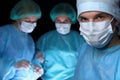 Closeup of surgeons performing operation. Focus on male doctor. Medicine, surgery and emergency help concepts Royalty Free Stock Photo