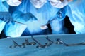 Closeup of surgeons performing operation. Focus on professional tools. Medicine, surgery and emergency help concepts