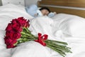 Closeup of a surprise red rose bouquet on bed for wife Royalty Free Stock Photo