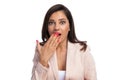 Closeup of surprised businesswoman gasping and covering her mouth