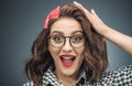 Closeup surprised face of young woman over dark gray - black background. Amazing girl yelling. Head shot of a amazed woman Royalty Free Stock Photo