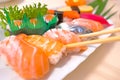 Closeup sushi with chopsticks In white plate . Japanese style Food Royalty Free Stock Photo