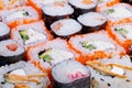 Closeup sushi rolls showcasing chef craft, handrolled texture and precise cuts, premium salmon and avocado, intimate kitchen Royalty Free Stock Photo