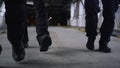 Closeup SWAT police officers legs walking in urban building