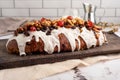 Closeup of sweet bread for the Christmas holiday with dry fruits and cream on a table Royalty Free Stock Photo