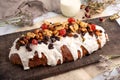 Closeup of sweet bread for the Christmas holiday with dry fruits and cream on a table Royalty Free Stock Photo