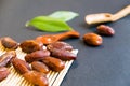 Closeup sweet dried date palm fruits or kurma, ramadan ramazan food. Natural light. Selective focus. Close up on a black backgro