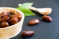 Closeup sweet dried date palm fruits or kurma, ramadan ramazan food. Natural light. Selective focus. Close up on a black backgro