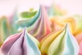 Closeup of sweet rainbow color and twisted meringue cookies. Concept of sweet food. Macro, soft focus