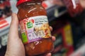 Closeup of sweet and sour sauce from Suzi Wan Brand in hand at Super U supermarket