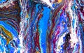 Closeup of a swirling abstract acrylic pour painting with blending greens, blues, and purples. Bright, extreme. Royalty Free Stock Photo