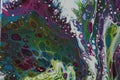 Closeup of a swirling abstract acrylic pour painting with blending greens, blues, and purples. Royalty Free Stock Photo