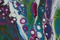 Closeup of a swirling abstract acrylic pour painting with blending greens, blues, and purples. Royalty Free Stock Photo