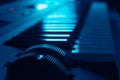 Closeup of synthesizer keyboard in dark ambient illuminated by blue light Royalty Free Stock Photo