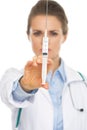 Closeup on syringe in hand of doctor woman