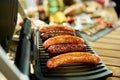 Closeup on table with electric grill and grilled sausages Royalty Free Stock Photo