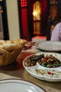 Closeup of a table in a restaurant with a Mezze Platter and a basket of fresh bread Royalty Free Stock Photo