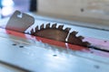 Closeup of a table saw blade guard under the lights with a blurry background Royalty Free Stock Photo