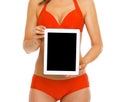 Closeup on tablet pc in hand of woman in swimsuit Royalty Free Stock Photo