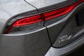 Closeup of the tail lights of a gray Toyota Mirai car with raindrops on it