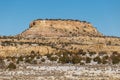 Closeup of tall rocky mesa plateau in snow covered desert on in rural New Mexico